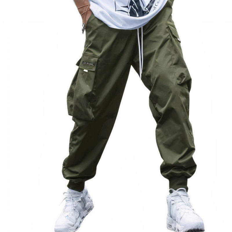 Mann in moderner Cargo-Hose mit weißem T-Shirt und Turnschuhen