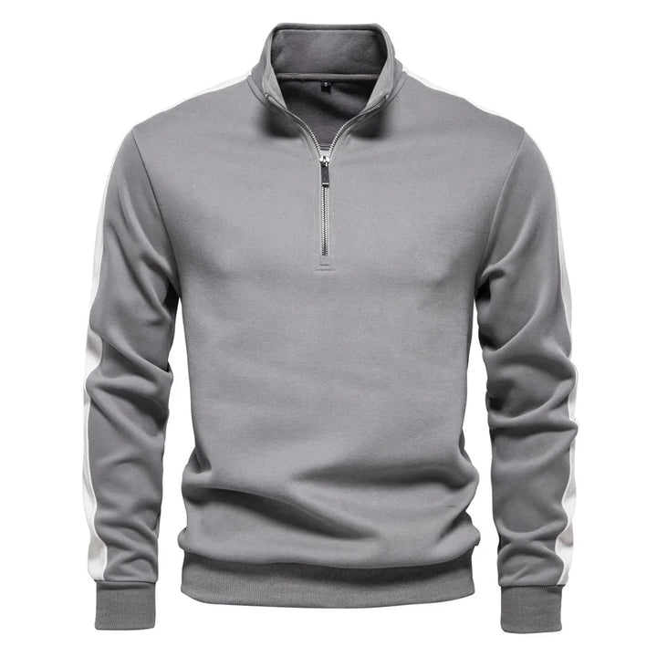 Moderner Herrenpullover aus weichem Material mit Viertelreißverschluss und elegantem Schnitt.