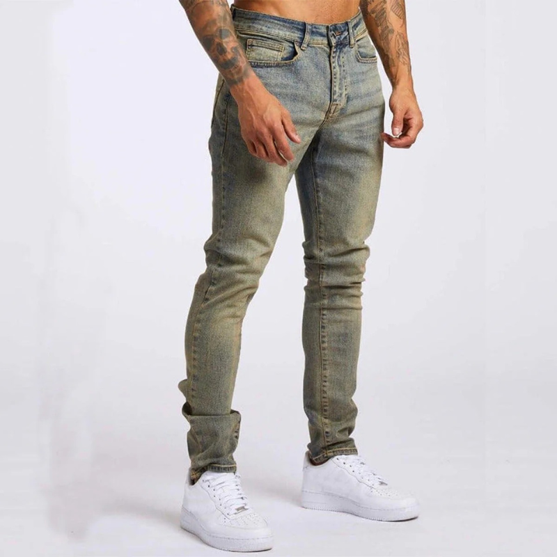 Mann trägt Slim-Fit Mid-Rise Stretch-Jeans mit Hemd und Sneakers