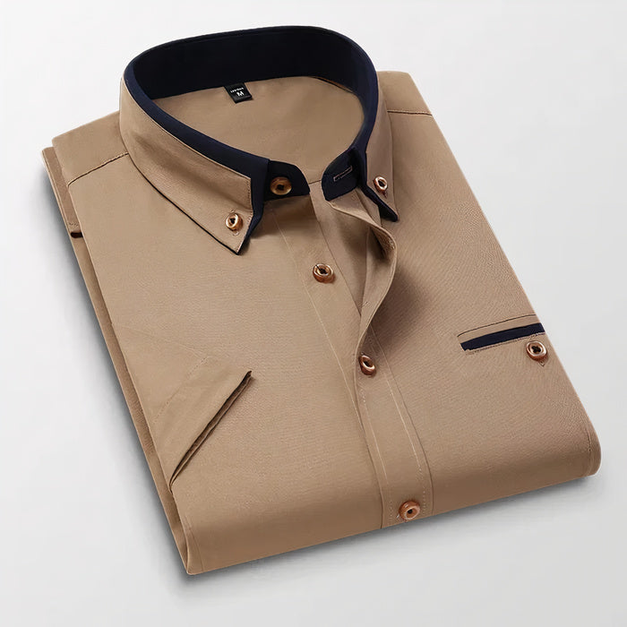 Mann in klassischem weißen Business-Button-down-Hemd steht selbstbewusst da
